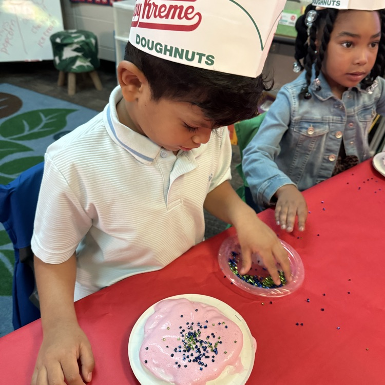 student decorating donut craft
