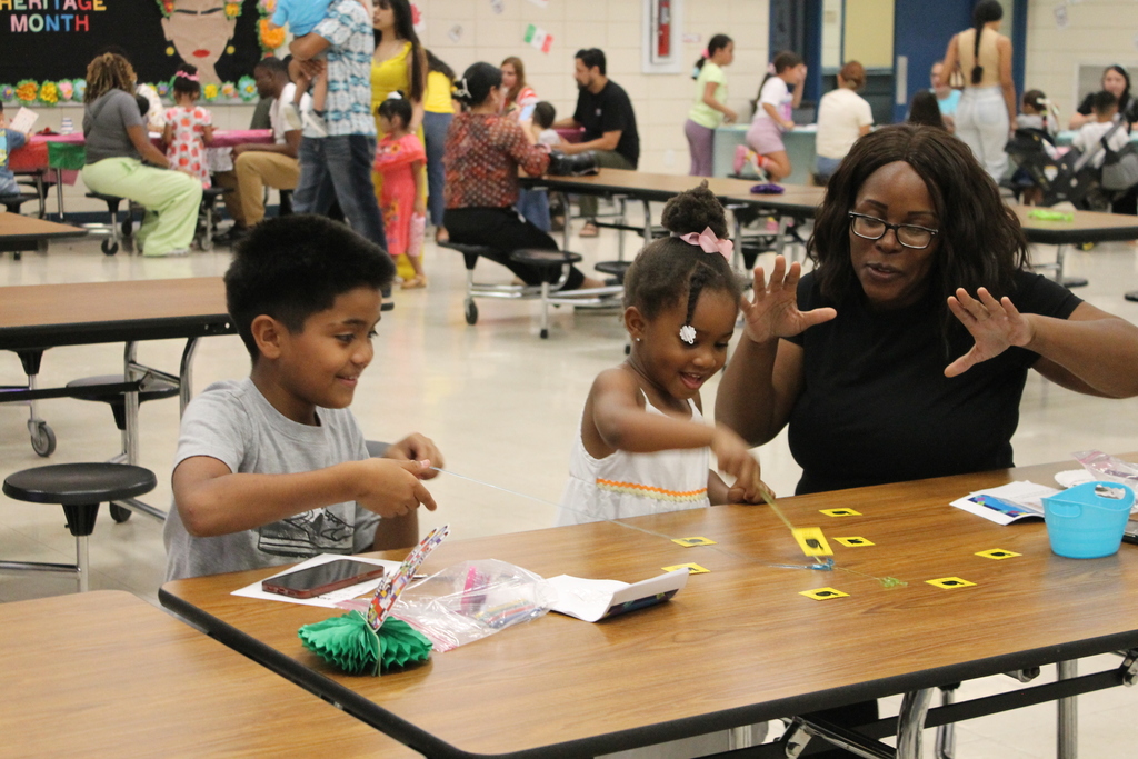 An ECC family plays a literacy game together at HHM Literacy Night