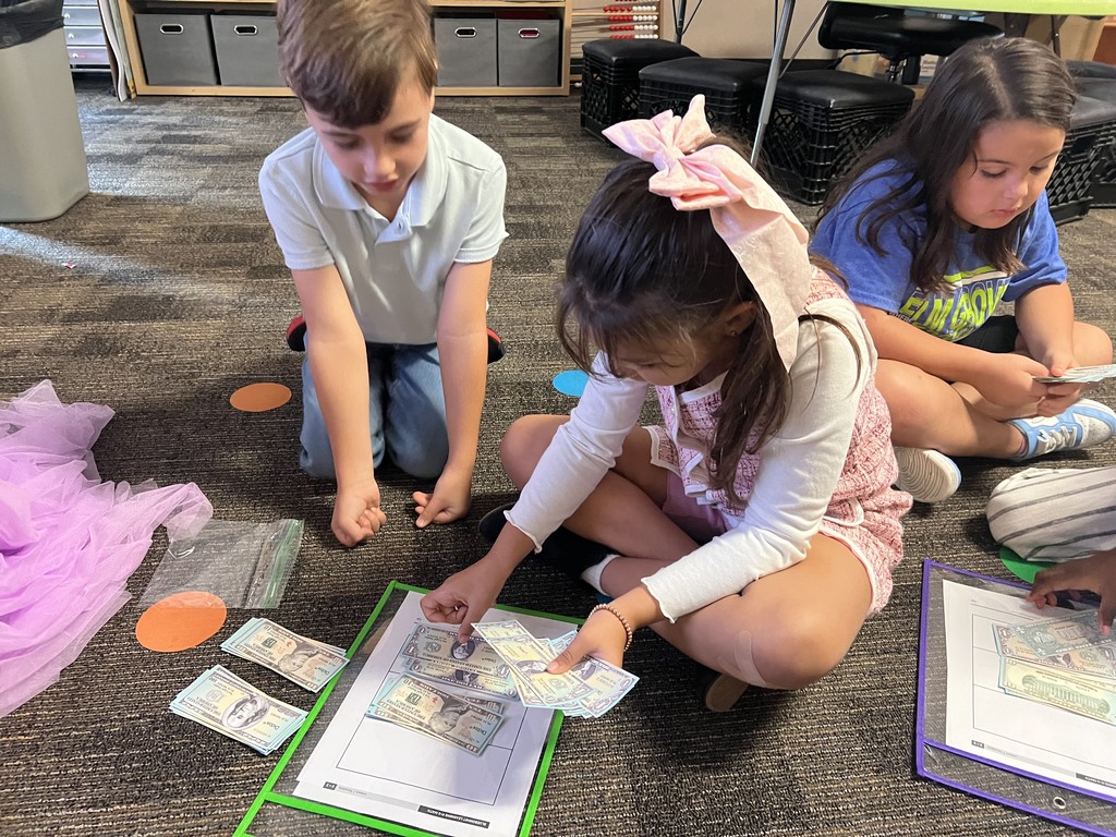 Second grade students collaborating to count money