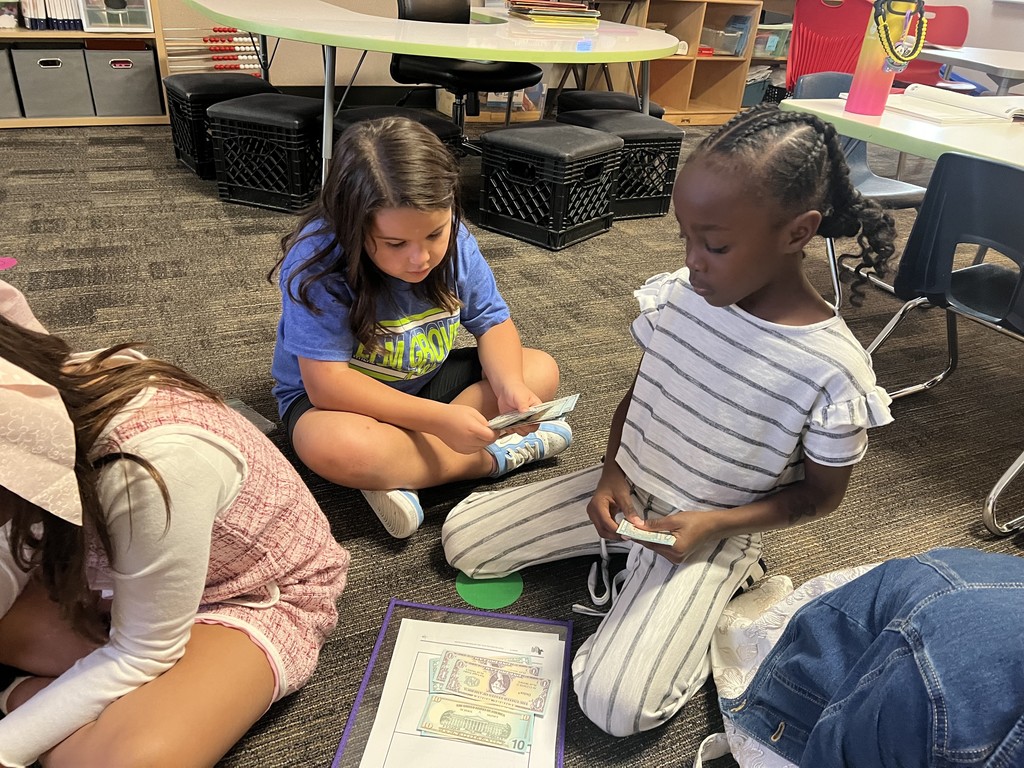 Second grade students collaborating to count money