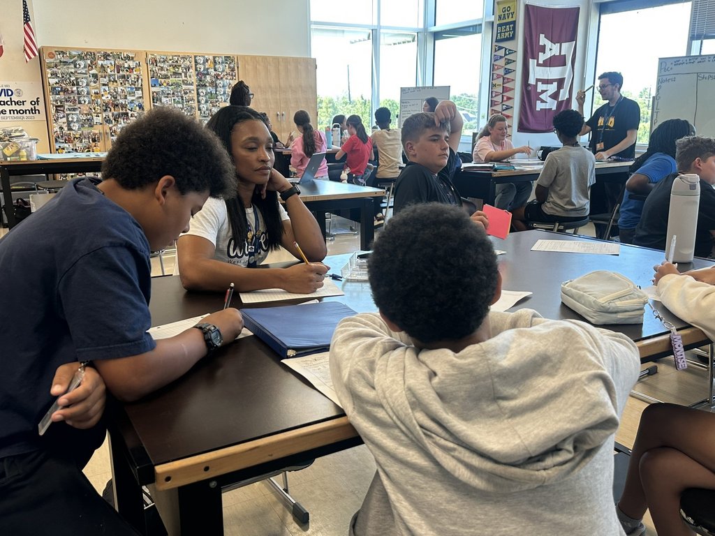 Students sitting at table working on an assignment
