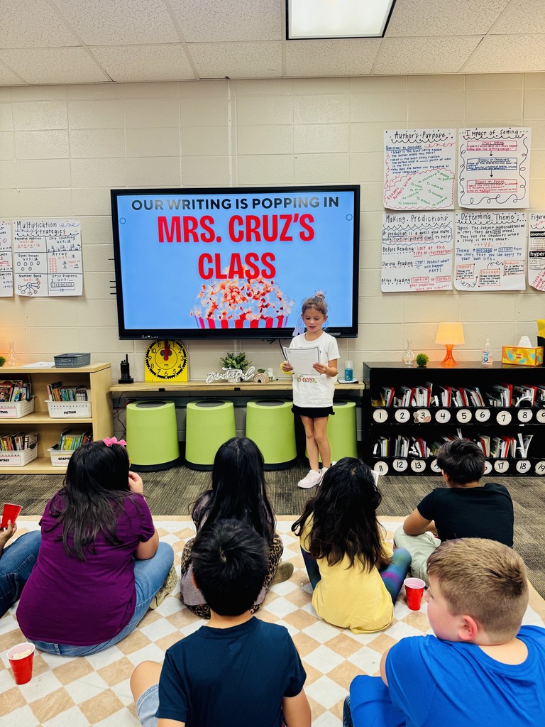 A student is sharing her writing with the class.