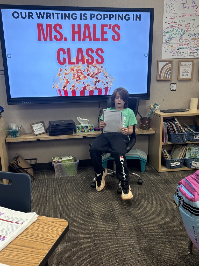 A students is reading his writing to the class.