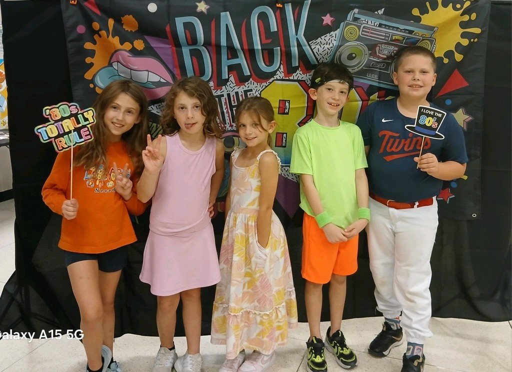 Students at the 80s dance party posing for a picture.