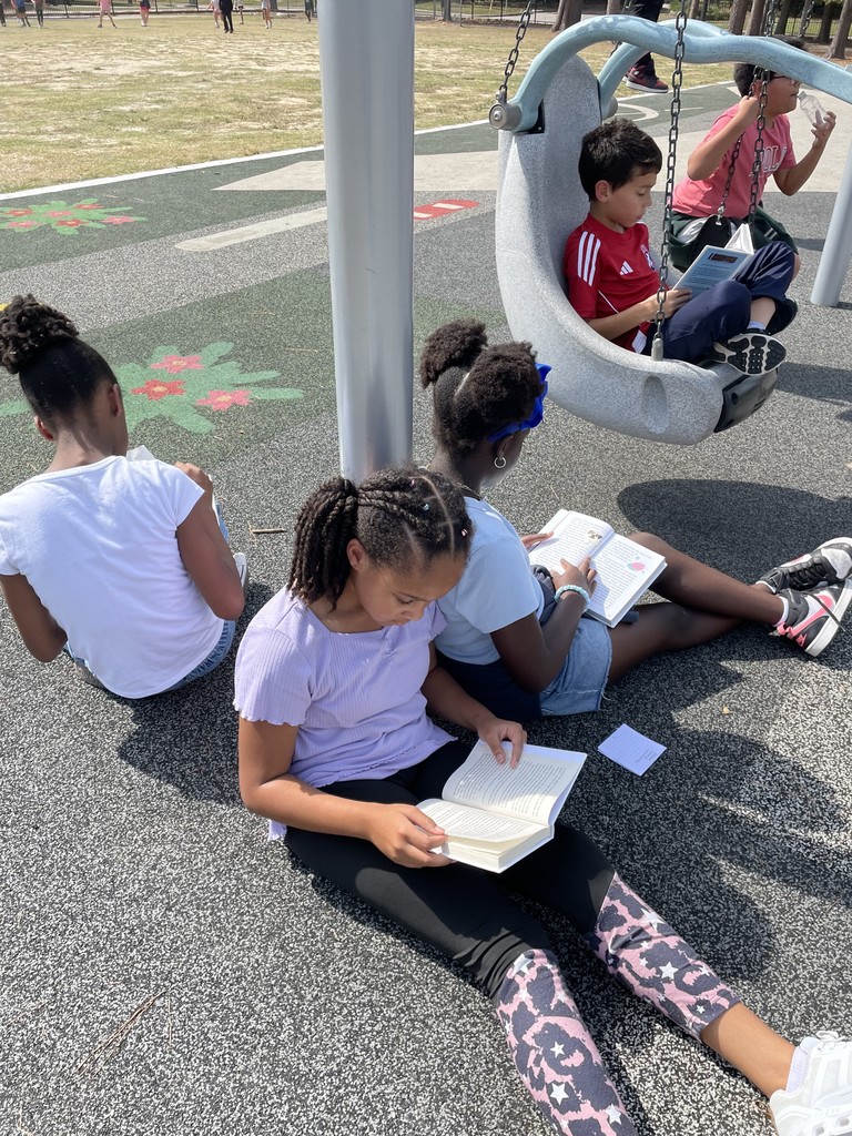 Students reading on the playground