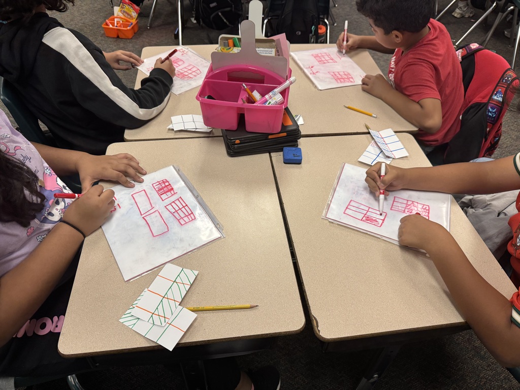 Students working on adding fractions with unlike denominators using pictorial representations.