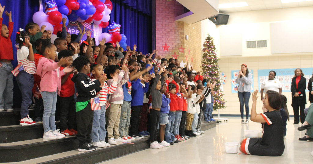 Specials teachers Radklao Sripunya and Lisa Sonnier direct as students perform at the Veterans Day Program.