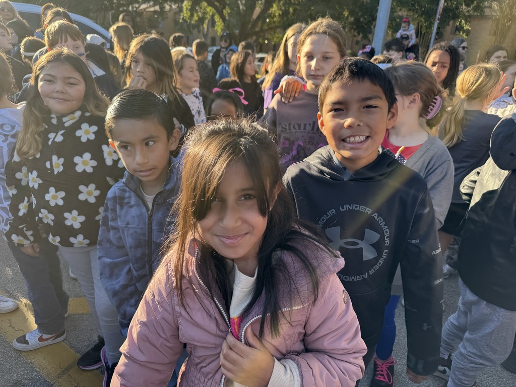 Students watching Veteran's Day service.