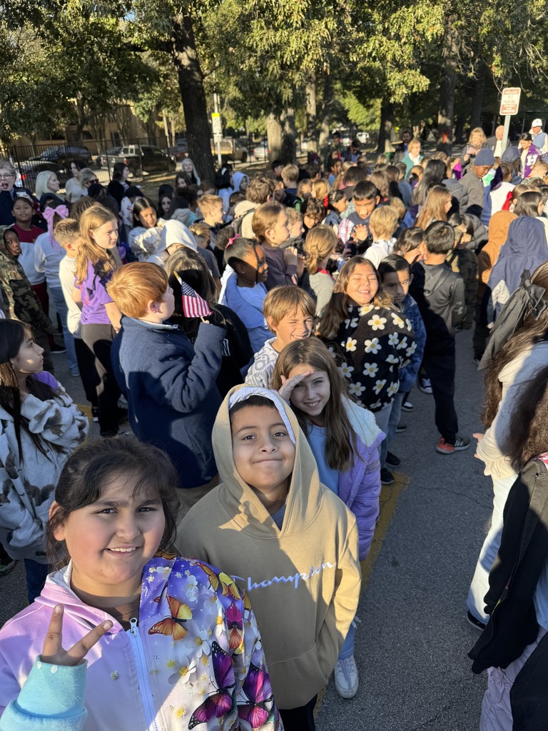 Students watching Veteran's Day service.