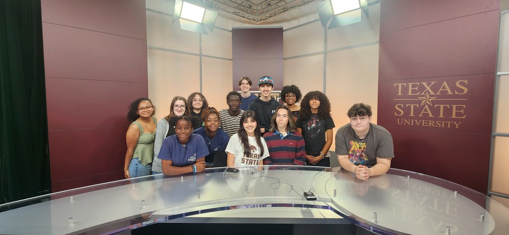 Students behind the anchor desk