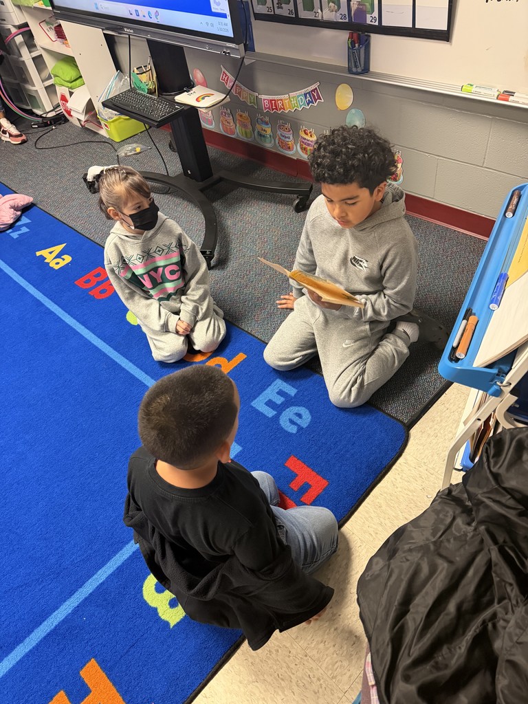 2nd graders reading to Kindergarten