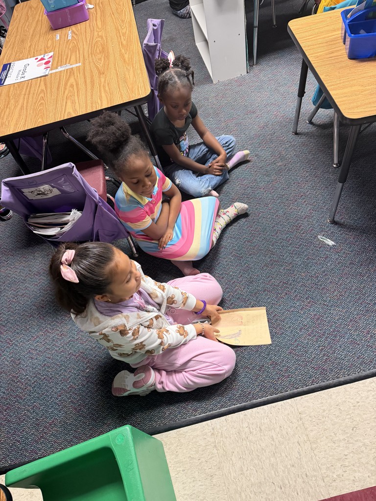 2nd graders reading to Kindergarten