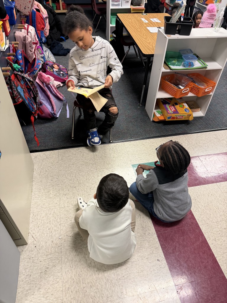 2nd graders reading to Kindergarten