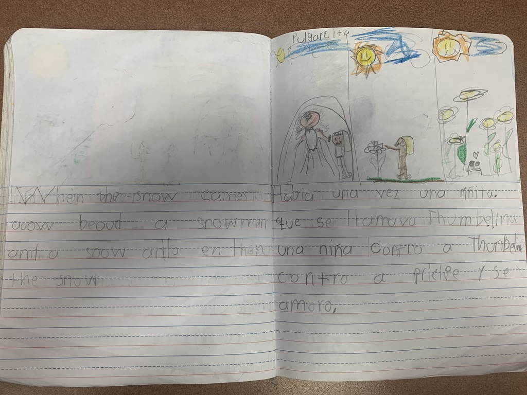 a student journal with writing in English and Spanish