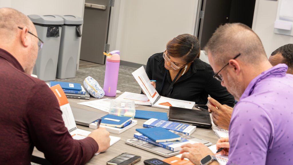 Teachers reading about ways to handle difficult conversations in a group