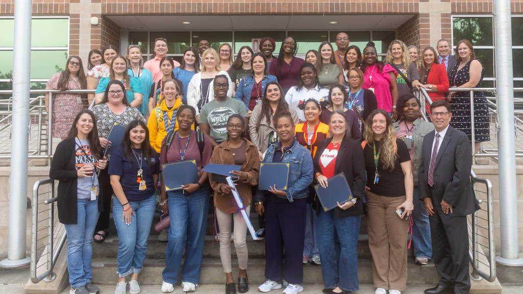group of teacher and mentors on the stairs with Humble ISDs superintendent 