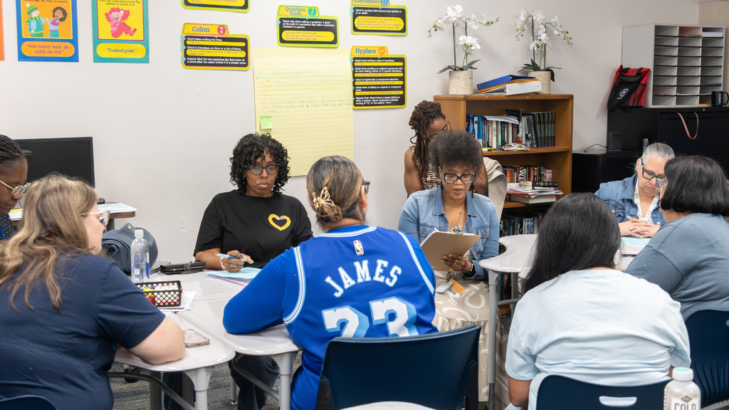 teachers gathering in small groups to discuss