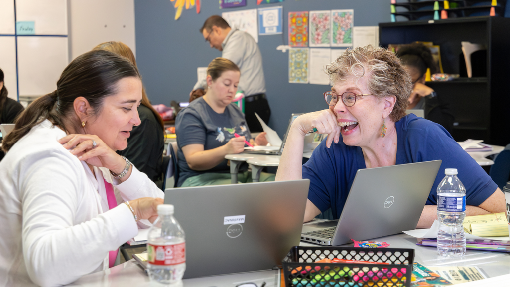 teachers laughing on laptops