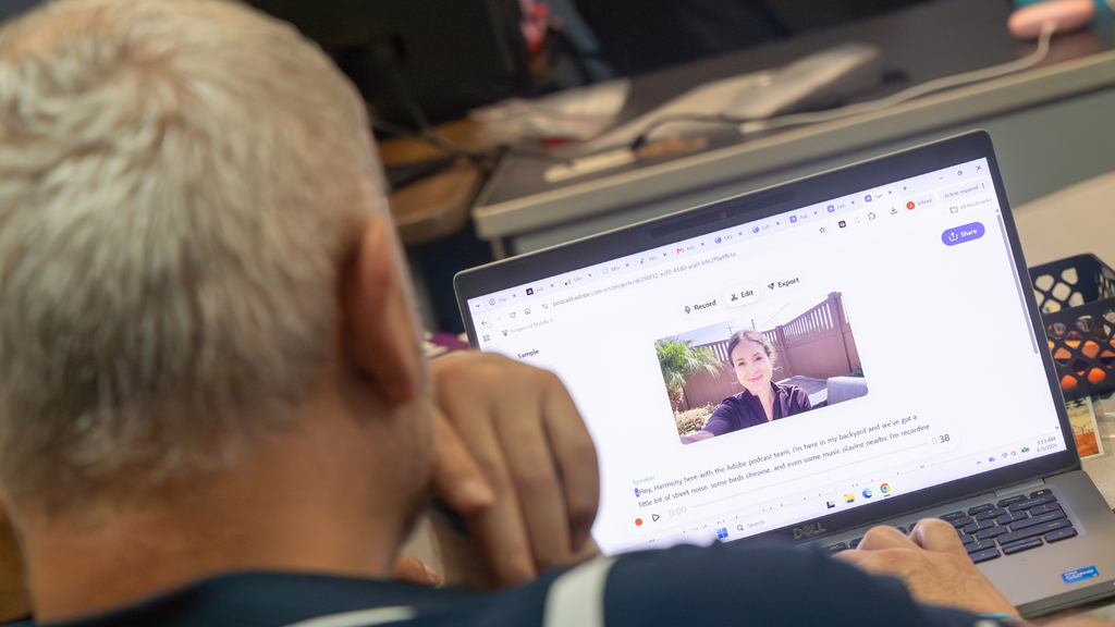 Man on computer exploring ai powered podcasting