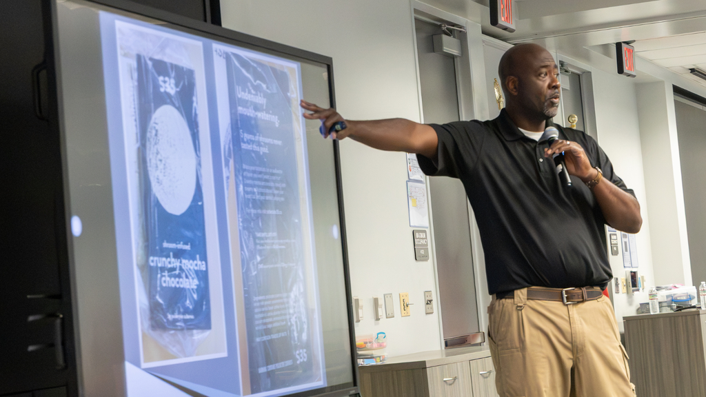 man pointing to screen during a presentation