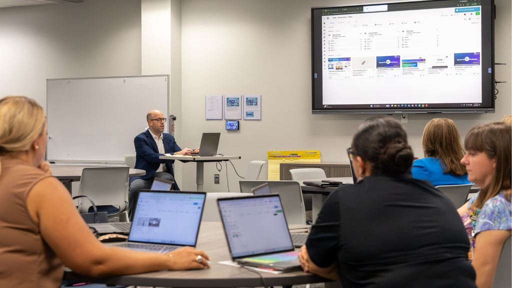 teachers with laptops learning from an instructor with a laptop