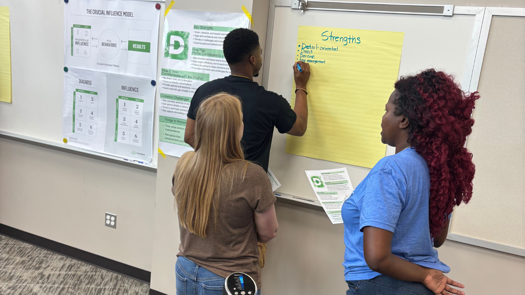 leaders standing and writing notes on chart paper
