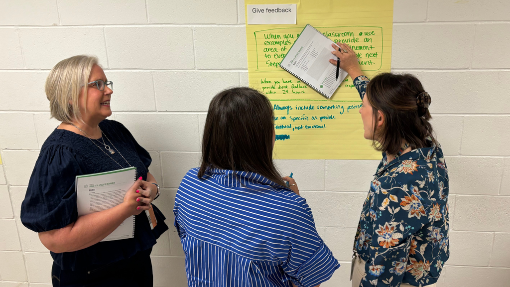 group of educators standing and discussing