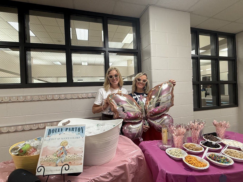 Two  Principals passing out snacks to teachers and staff