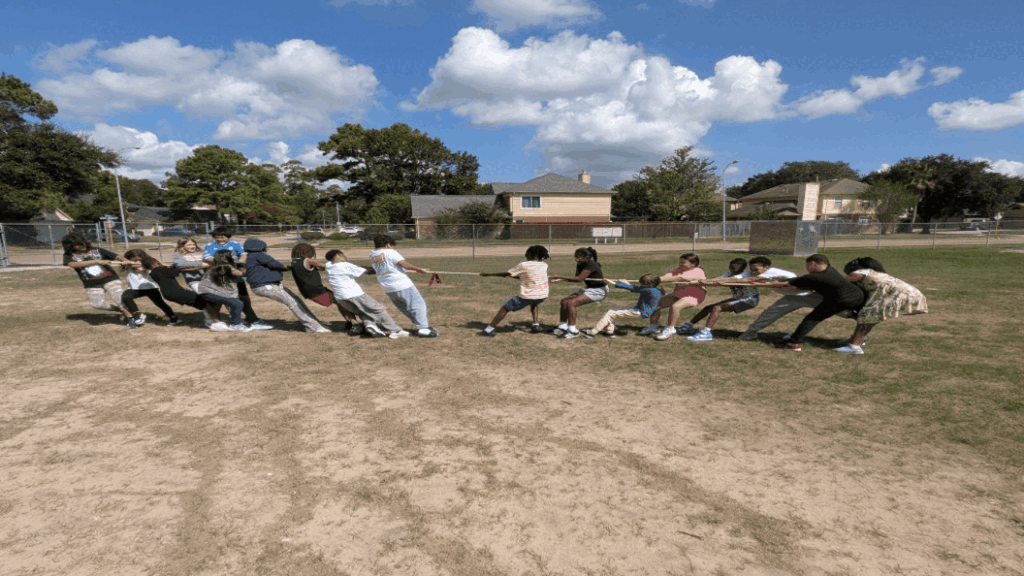 Unequal-students playing tug of war and the left hand side team wins
