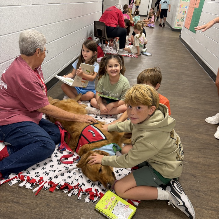 kids reading to paws for reading dogs