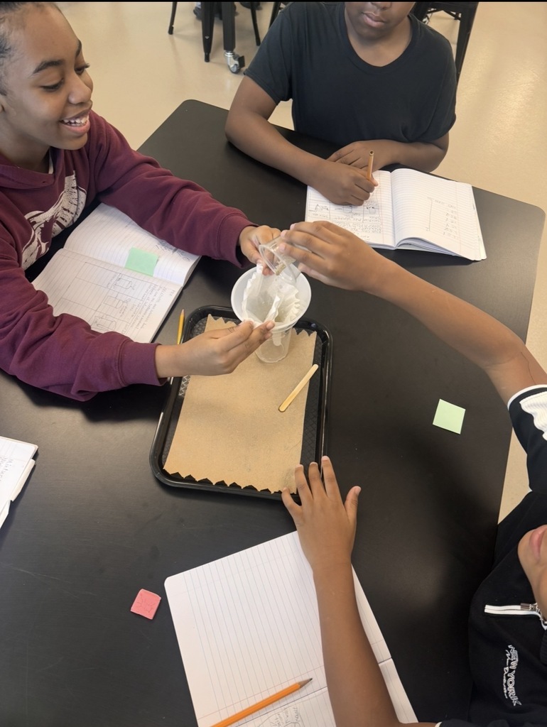 Students filtering out their sand and saltwater solution.
