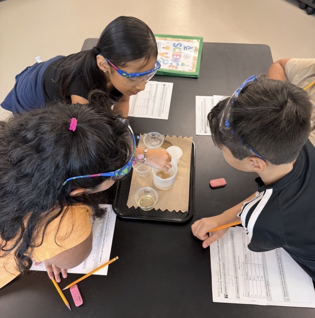 Students stirriing to see if the material is dissolvable in water.
