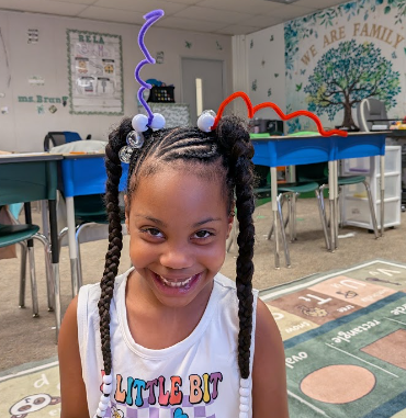 Student wearing pipecleaner antennas 
