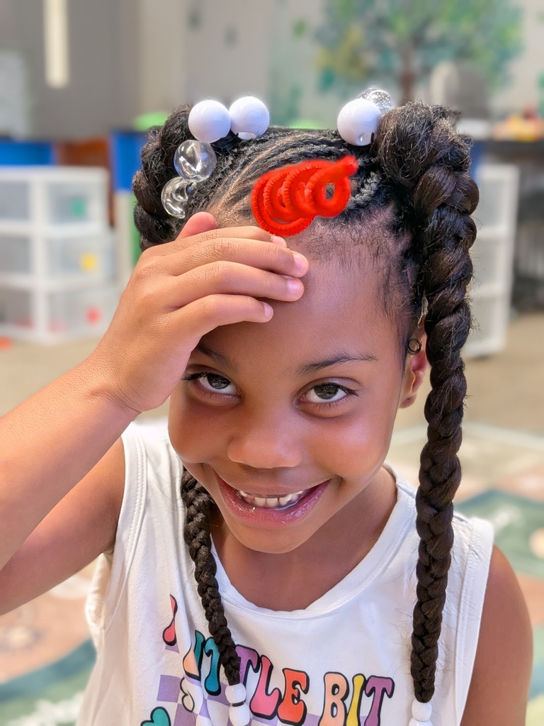 Student showing off her pipecleaner unicorn horn