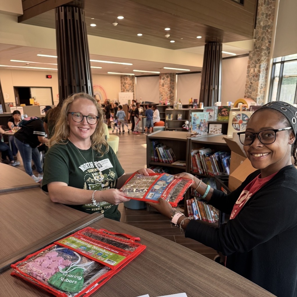 PFE Liaison, Ms. Gray, checking out math resources to a parent.