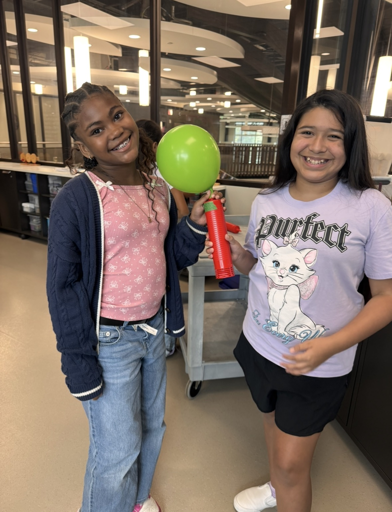 Students pumping air in their balloon rocket.