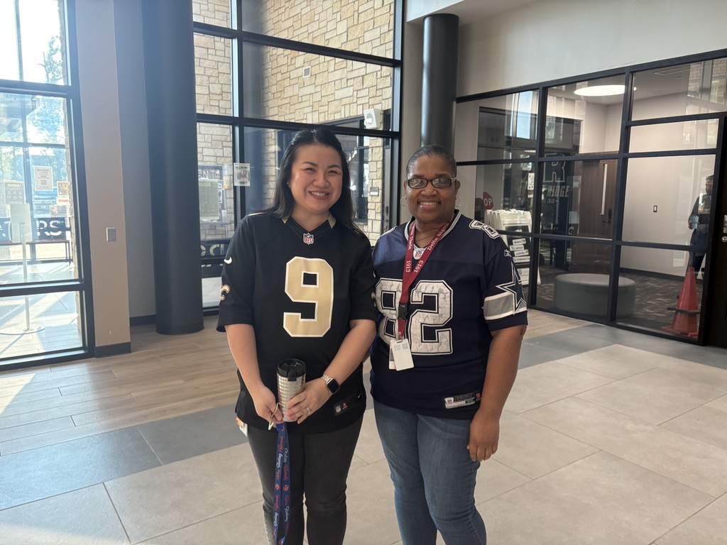 2 staff members dressed up in their jerseys for GFW day
