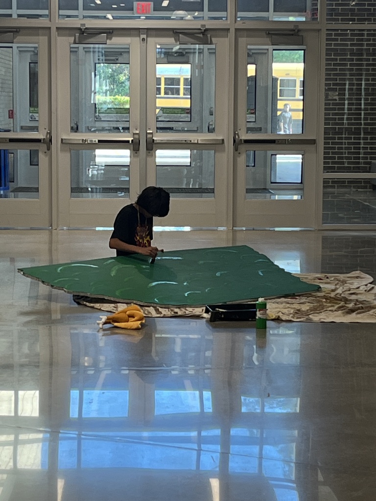 Student working on a theater set