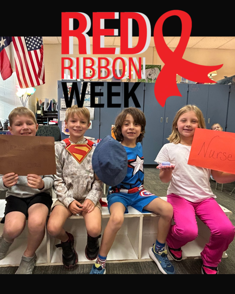 Four kids sitting on a bench holding signs, one with Nurse and one with a red ribbon.