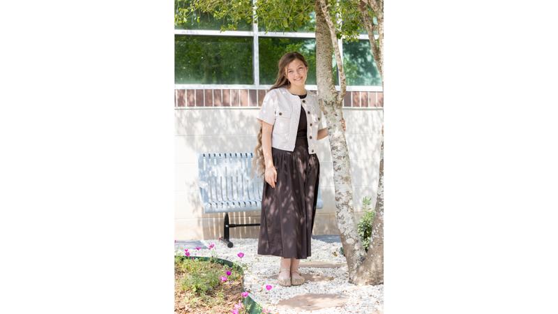 girl standing in front of tree