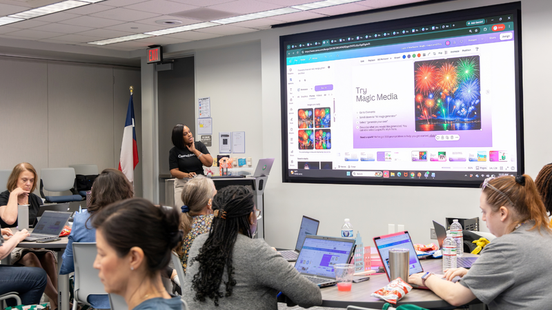 presenter from Canva looking up at screen while teachers follow along on their computers