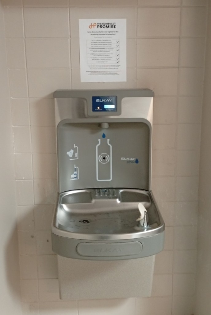 Poster by water fountain 