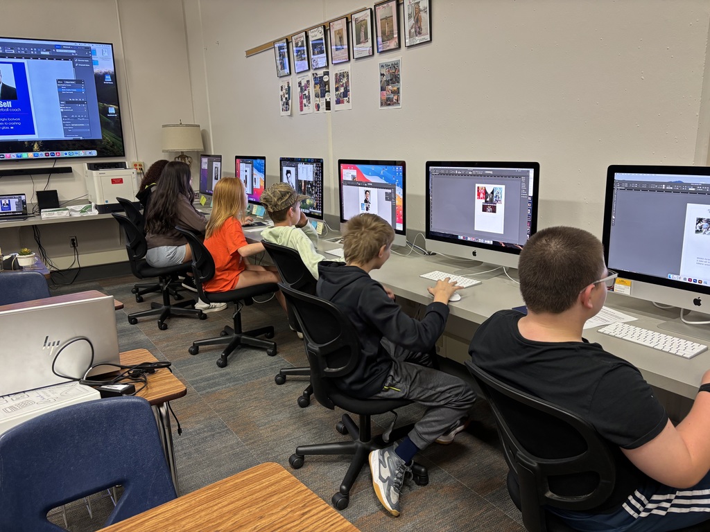 Students work on InDesign and Photoshop. 