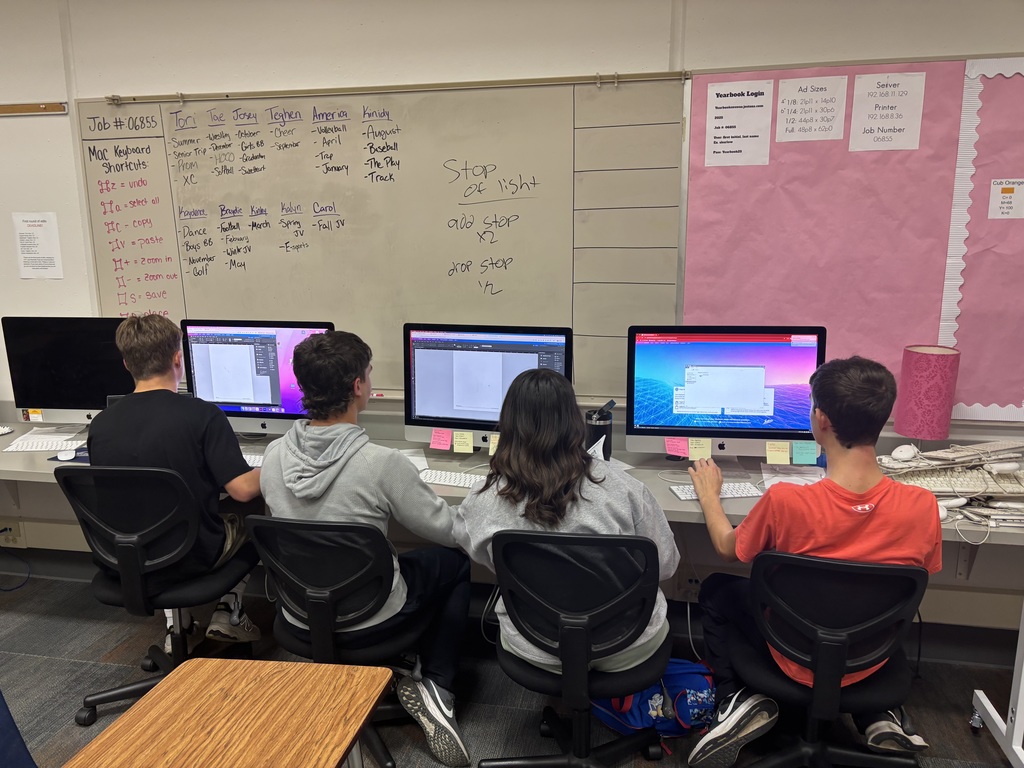 Students work on newspaper stories.