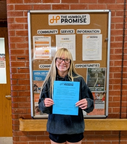 Freshman student holding time card