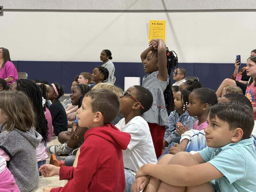 A group of students looking ahead at a show