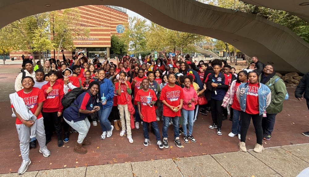 The entire fourth, fifth, and  sixth grade. standing  in front of the Tennessee Aquarium