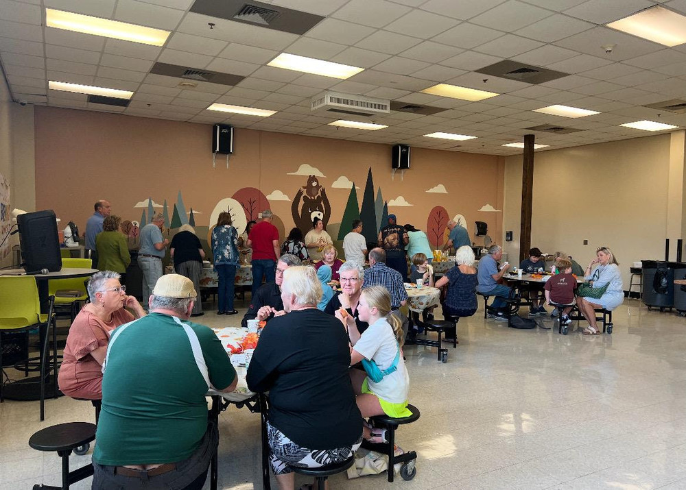 The cafeteria with grandparents and students enjoying grandparents breakfast