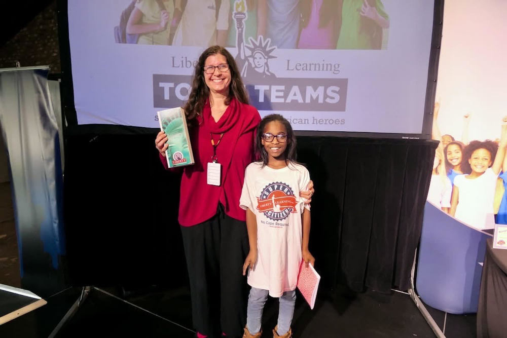 Chaffee Librarian Yuri Craig with 5th grade student at Liberty Learning Foundation