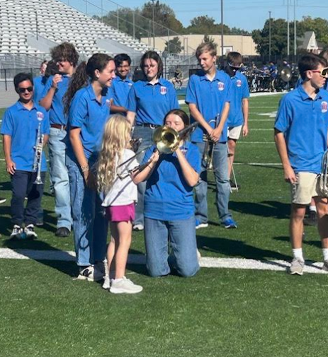 Huntsville High  Band students show a kindergartener how to play the trombone